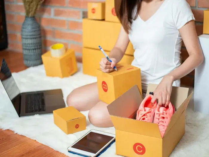 Entrepreneur preparing product boxes for online orders listed on towndirectorysource.com